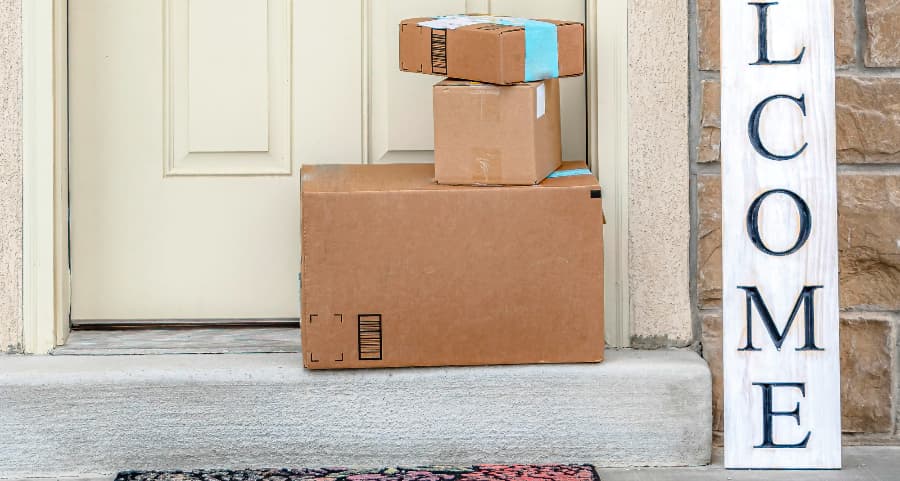 Deliveries on the front porch of a house with a welcome sign in Ann Arbor